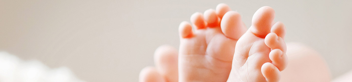 baby's feet in mother's hands