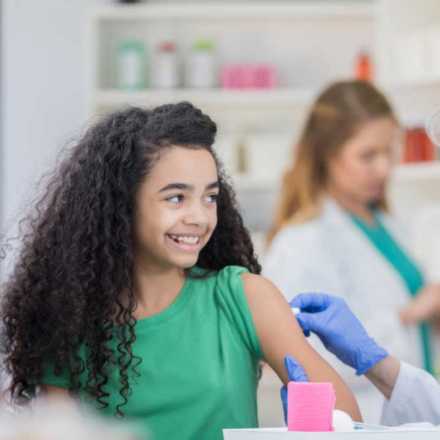 Young girl getting vaccine at pharmacy