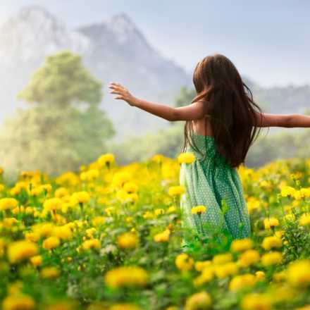 Girl in field of yellow flowers