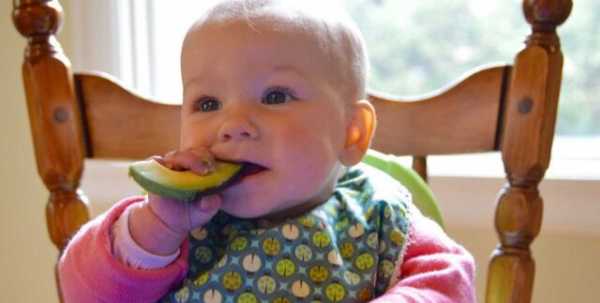 Baby eating avocado