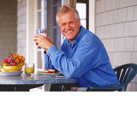 Man eating breakfast and smiling