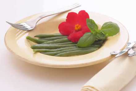 Green beans on a plate with flower garnish