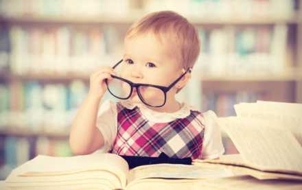 Baby wearing glasses at library