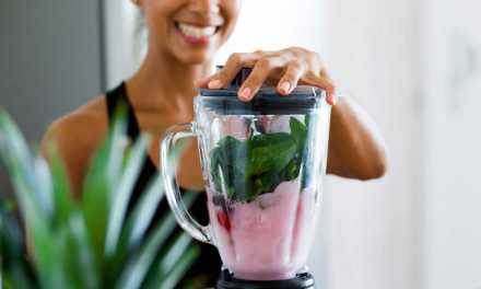 Woman making a smoothie in a blender
