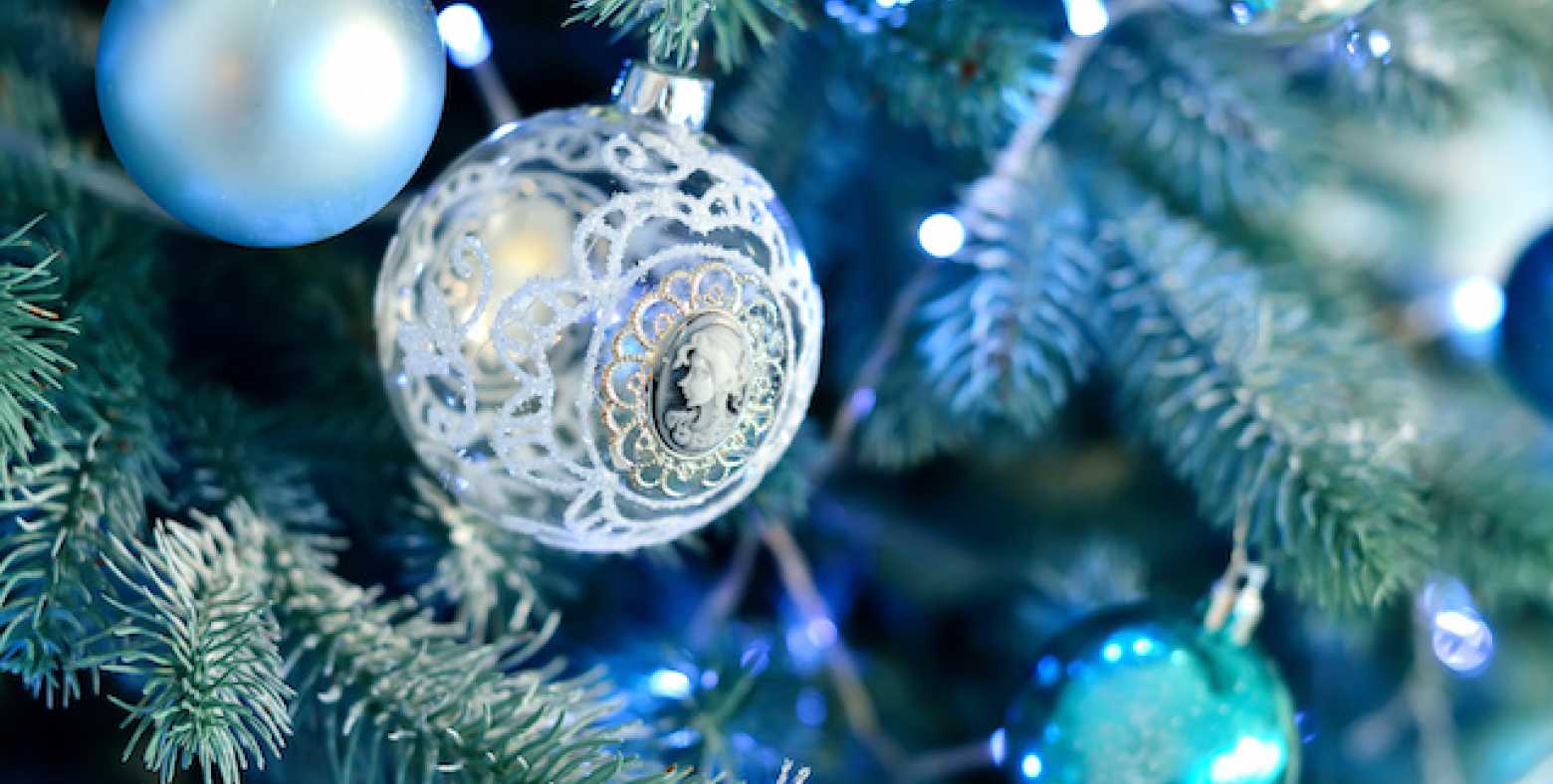 close up of hues of blue holiday ornaments on christmas tree