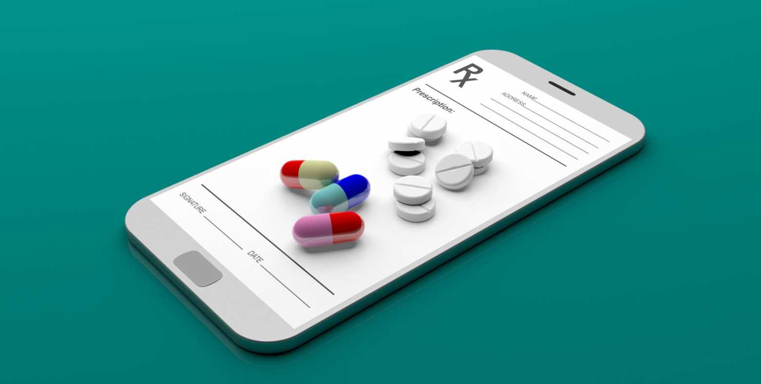 phone with image of online rx form and pills 