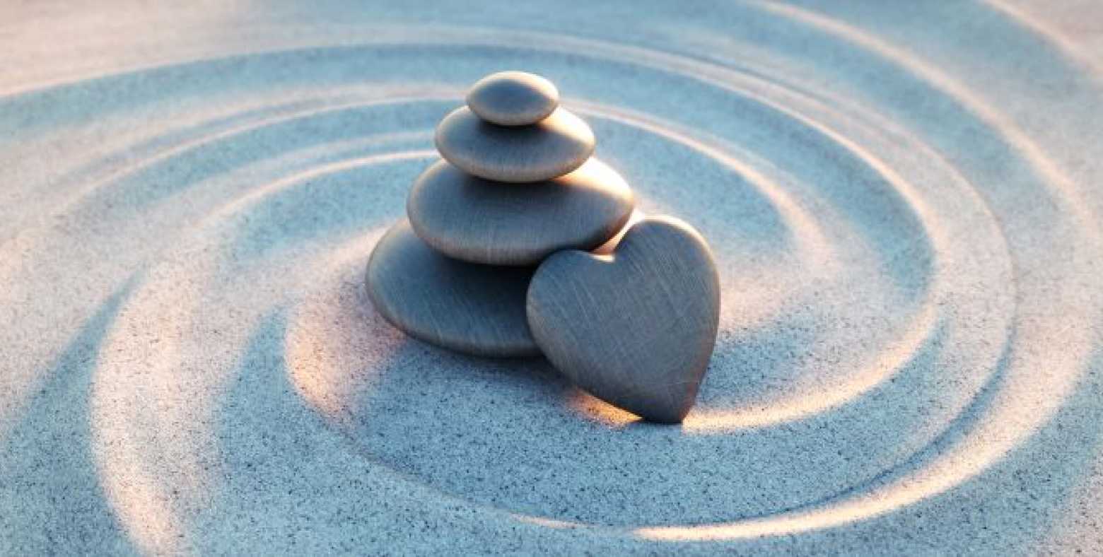 stacked rocks on swirled sand