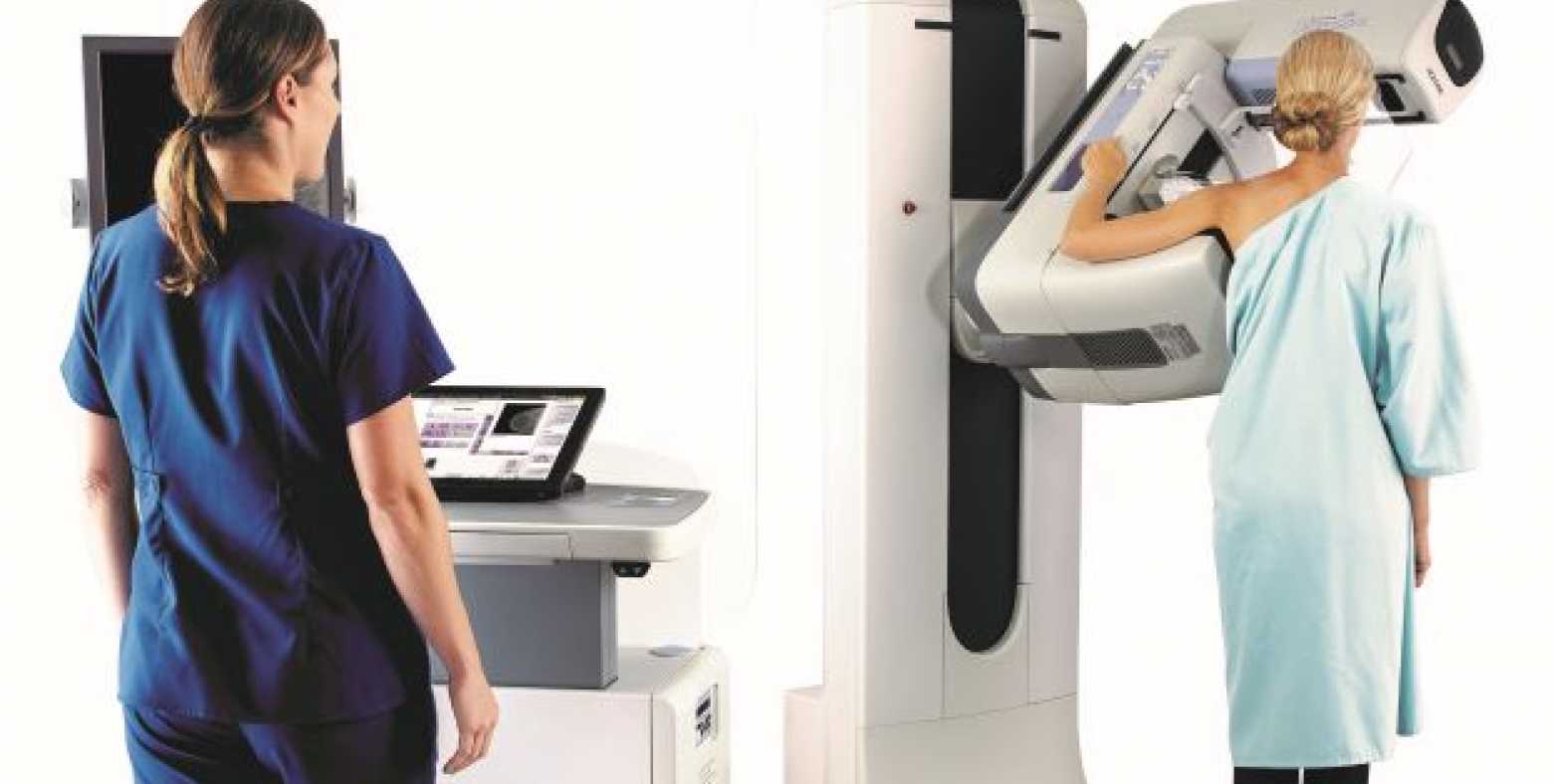 female tech and patient undergoing mammogram