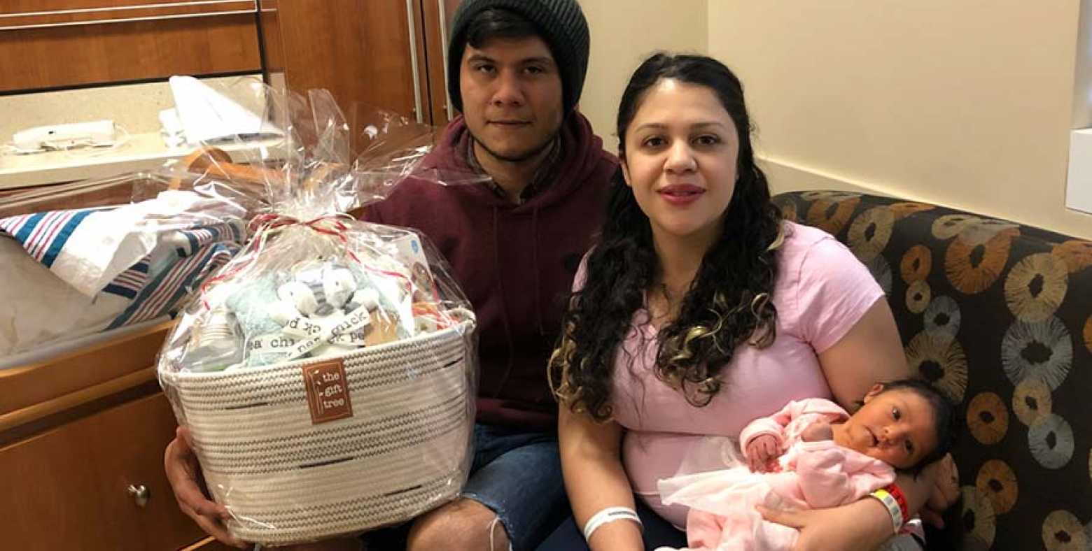 Father, Christian Meraz, Mother, Mayra Silva, and first baby of the new year, Leah Alessandra Meraz, with a gift basket donated by Tahoe Forest Health System Foundation’s gift shop, The Gift Tree 