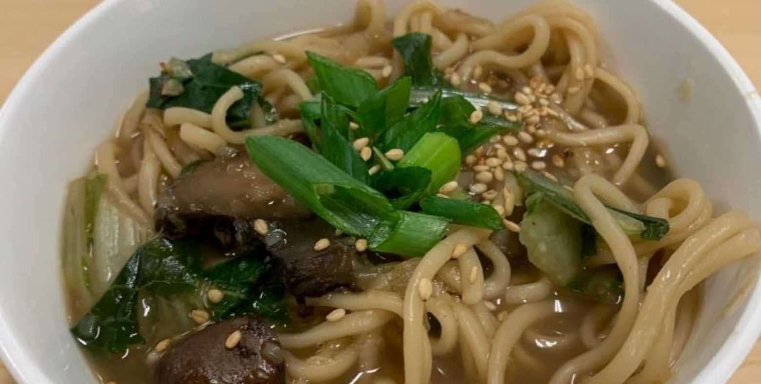 Bowl of ginger garlic noodle soup with bok choy