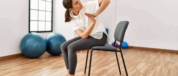 woman doing yoga pose on chair