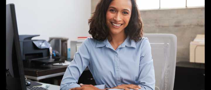 Smiling woman behind desk