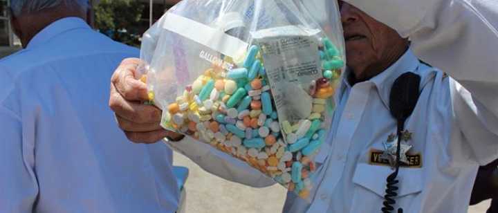 gentleman holding bag of prescription collected from drug take back days