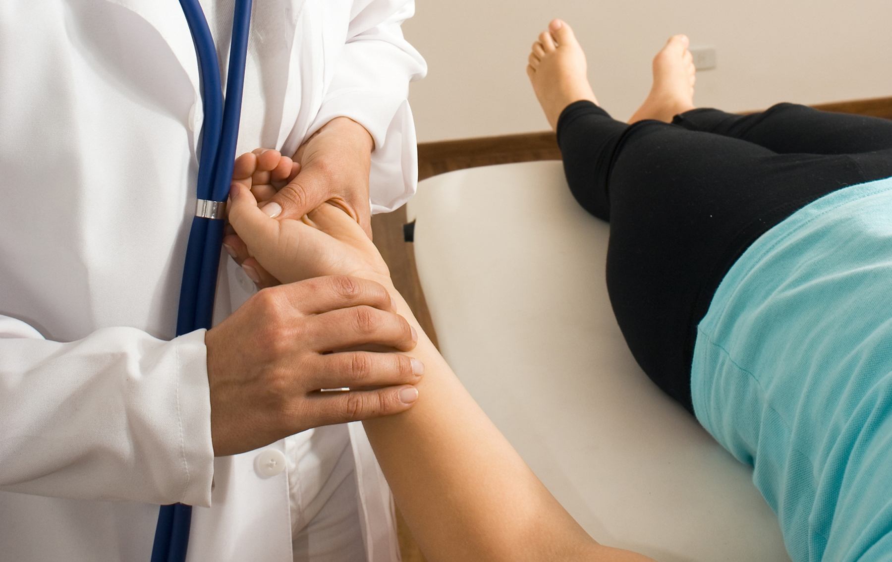 nurse taking patient's pulse at the wrist