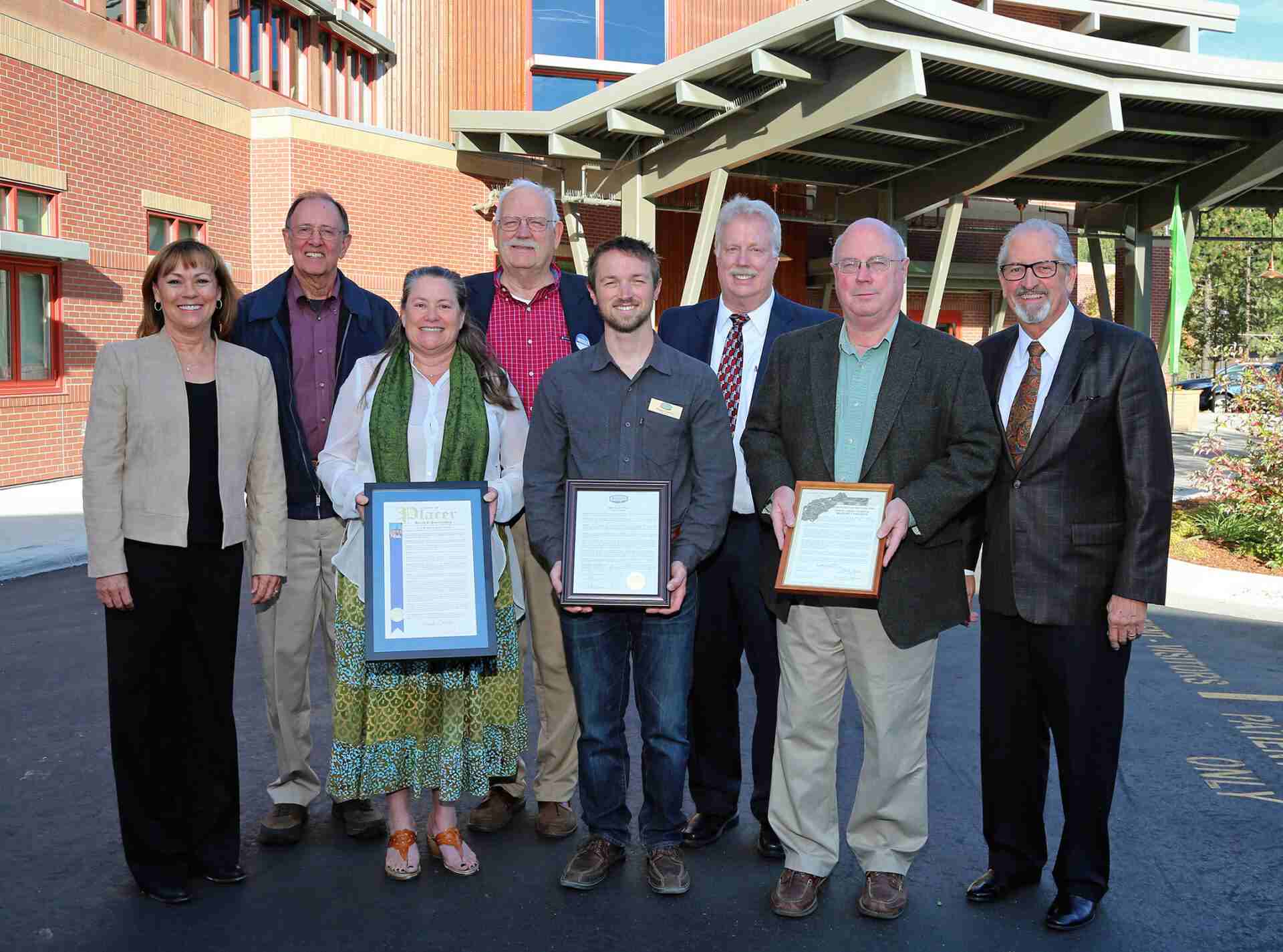 Speakers01 Leadership group holding framed certificates