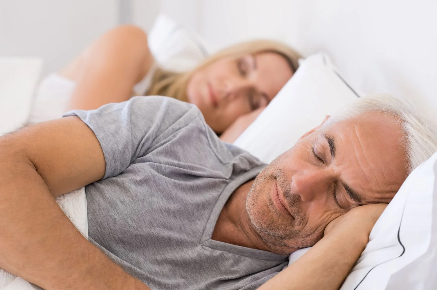 Couple sleeping on bed