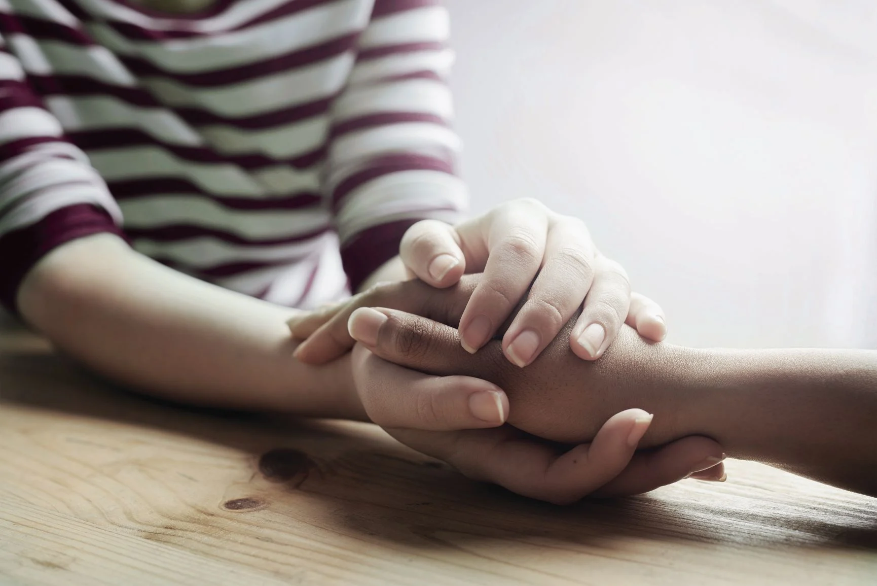 BehavioralHealth_small person grasping another person's hand