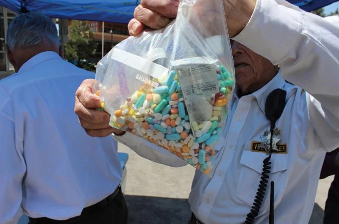 gentleman holding bag of prescription collected from drug take back days