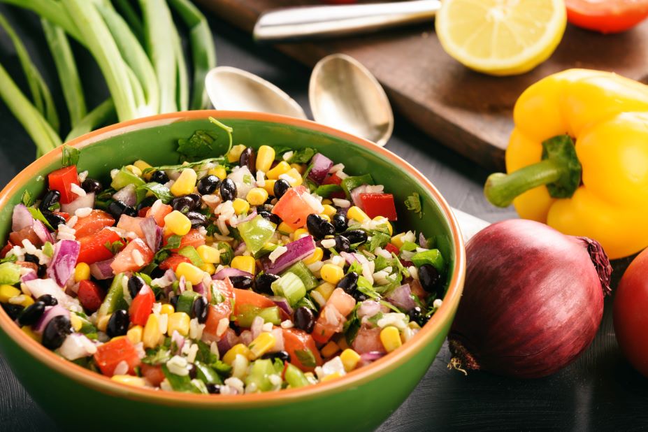 AdobeStock_157186681.web_ bowl of cowboy caviar with bell pepper and red onion beside bowl