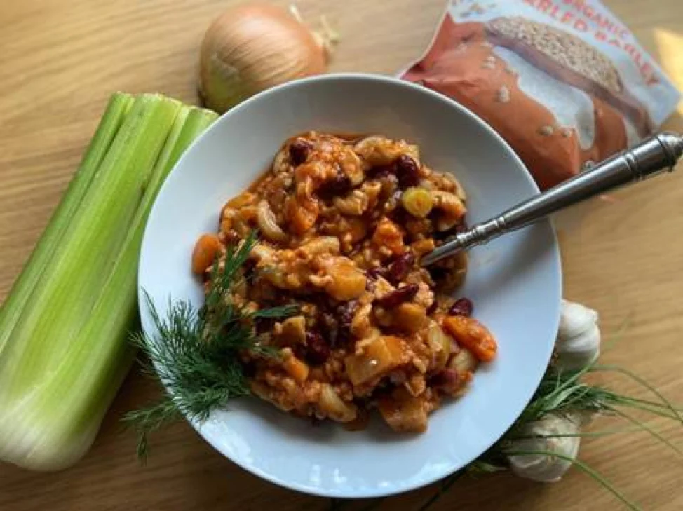 Bowl of Garden Minestrone Soup with vegetables around bowl