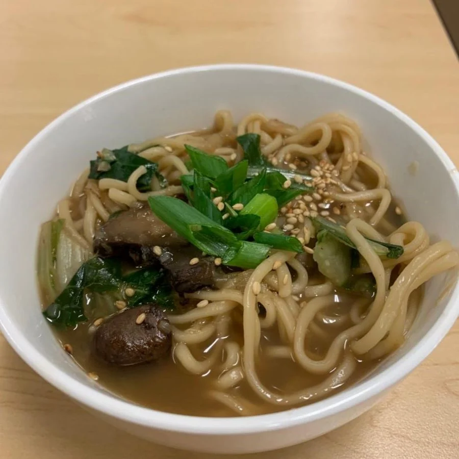 Bowl of ginger garlic noodle soup with bok choy