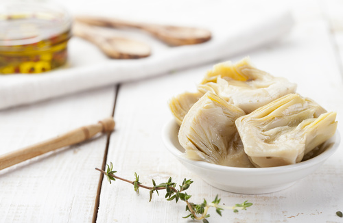 Artichoke hearts marinated in olive oil a small white bowl artichoke hearts
