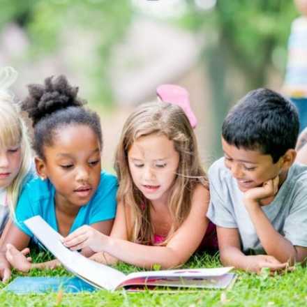 unnamed (17)(1) kids reading in the grass