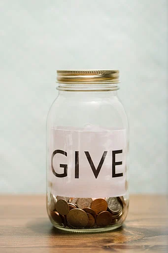 Charity jar give jar with coins