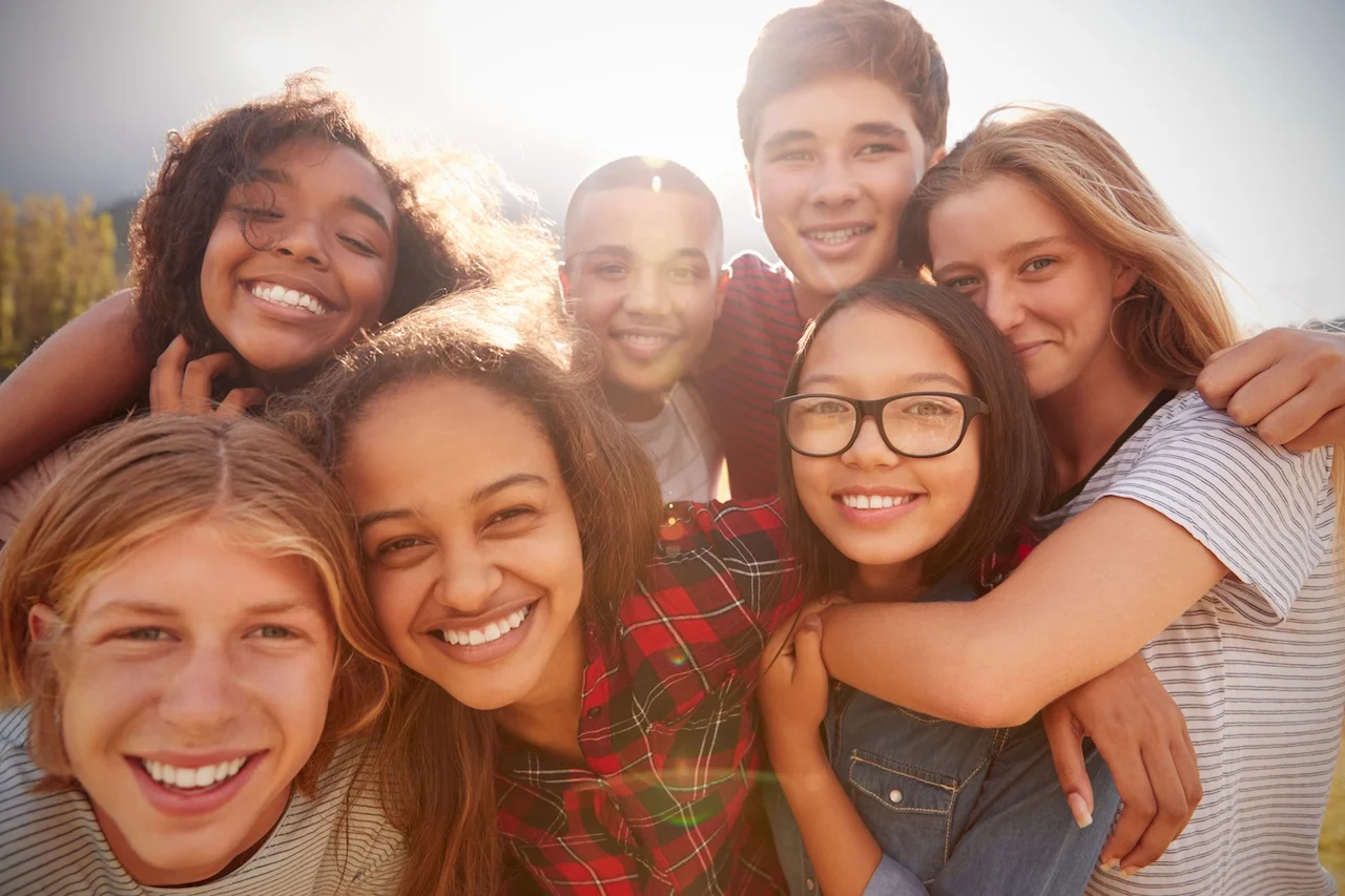 Teenage school friends smiling to camera, close up smiling teenagers