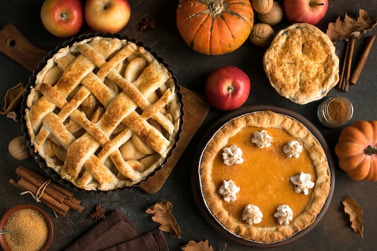 AdobeStock_221420720 web Variety of fall pies with fall decor
