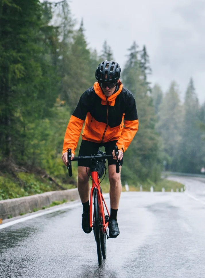 biking man road biking on a rainy day
