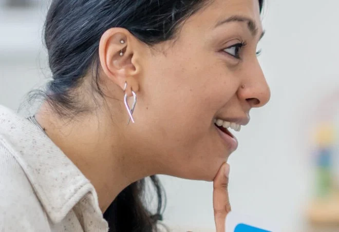 speech therapist pointing to her mouth