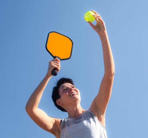 pickleballserve woman about to serve a pickleball