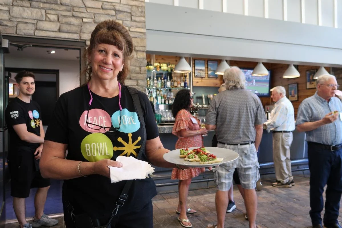 receptionsmile smiling incline bowl staff holding plate of tasty bites