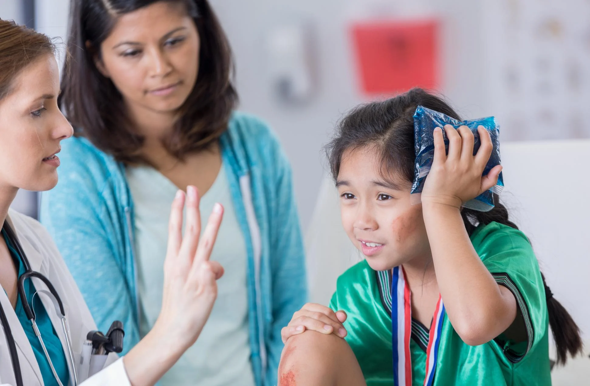 doctor tests girl's vision while she ices her head