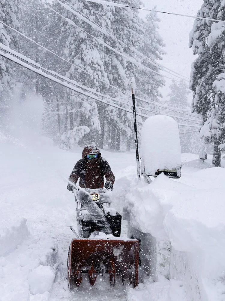 person snow blowing