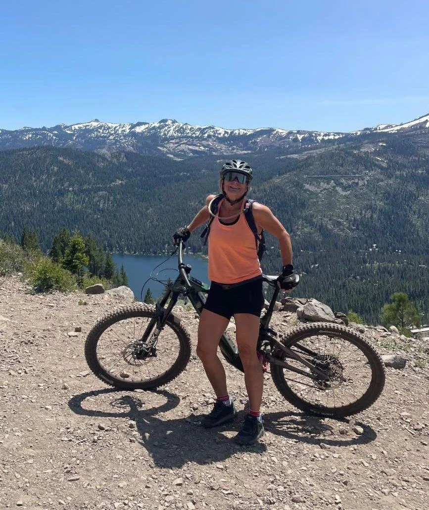 Dr. Nina Winans Dr. Nina Winans standing with her mountain bike