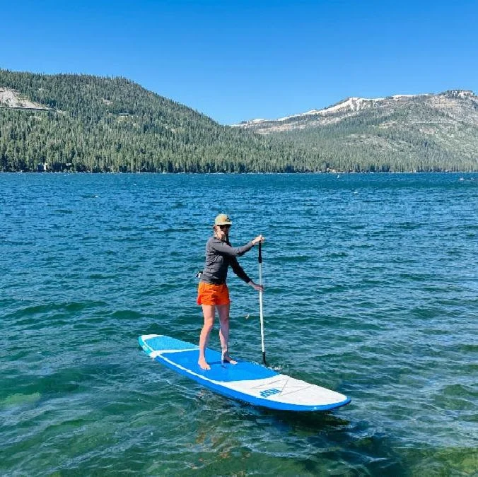 SUP Person stand up paddling on a lake