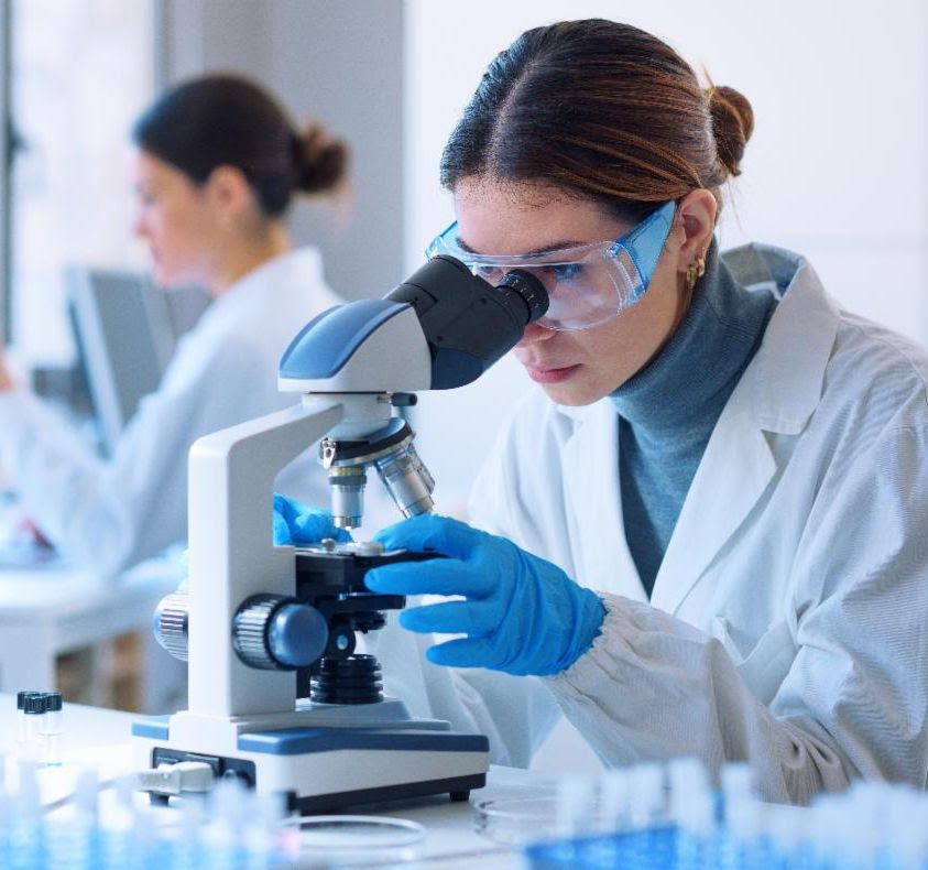 microscope person looking into microscope