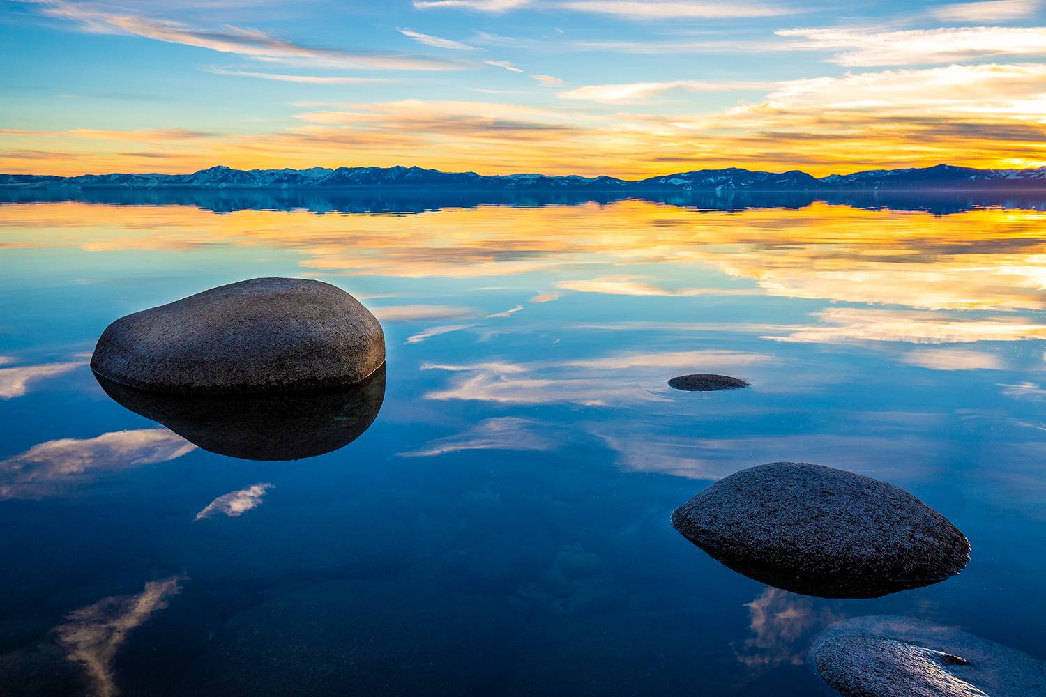 yellow sunset reflected in lake tahoe water