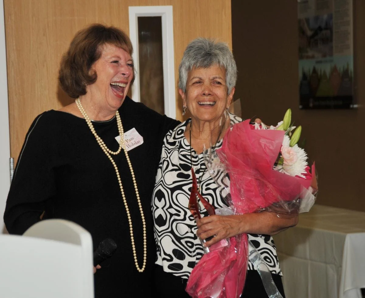 Pam Hobday and Marie Clukey holding bouquet of flowers