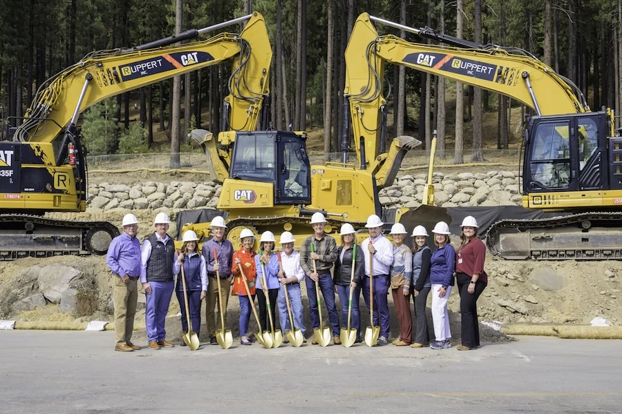 20250924_TFHD_026 copy 2 group of TFHS employees stands in front of construction machinery with shovels in hand