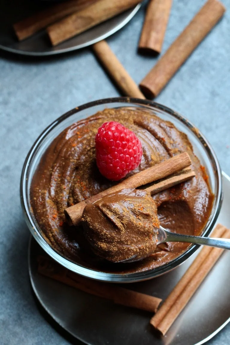 chocolate pudding with cinnamon sticks and raspberry