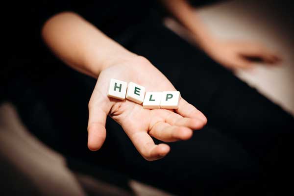 hand holding tiles reading help