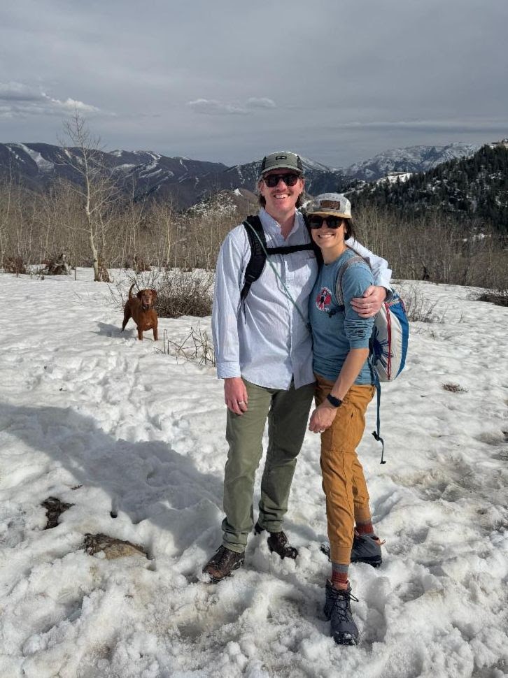 Whitney Liehr and husband and dog on a snowy hike