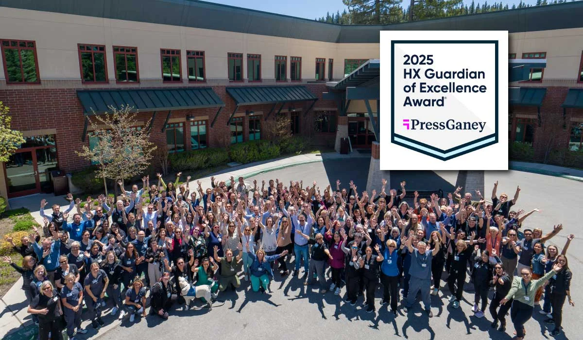 TFHS staff in front of TFH with 2025 Press Ganey Award logo