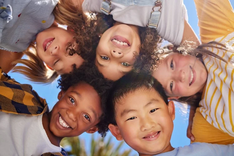 AdobeStock_588721830.web ground view of smiling children