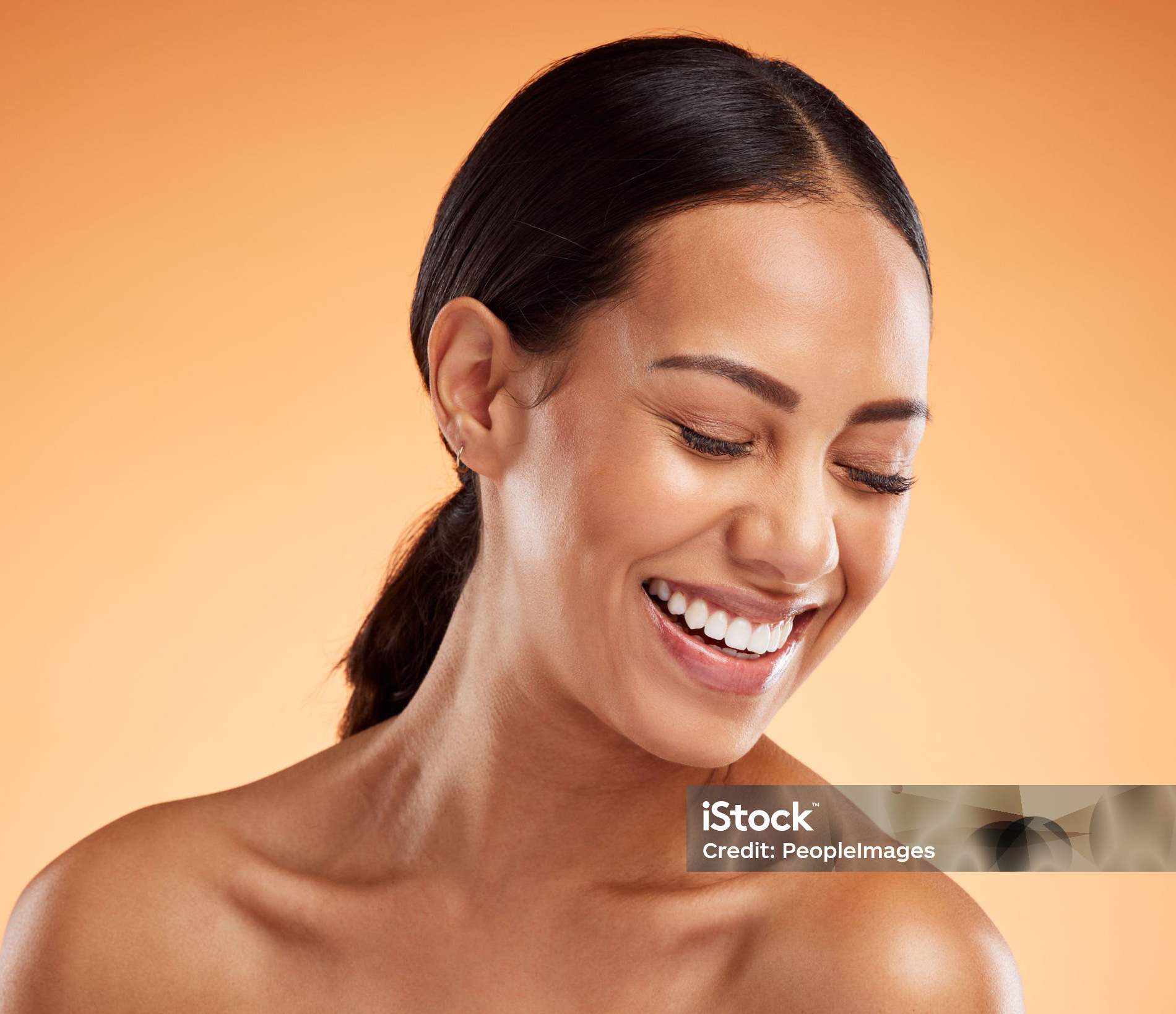 Woman smiles with eyes softly closed