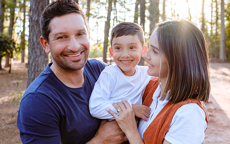 Dad, mom and child in the woods