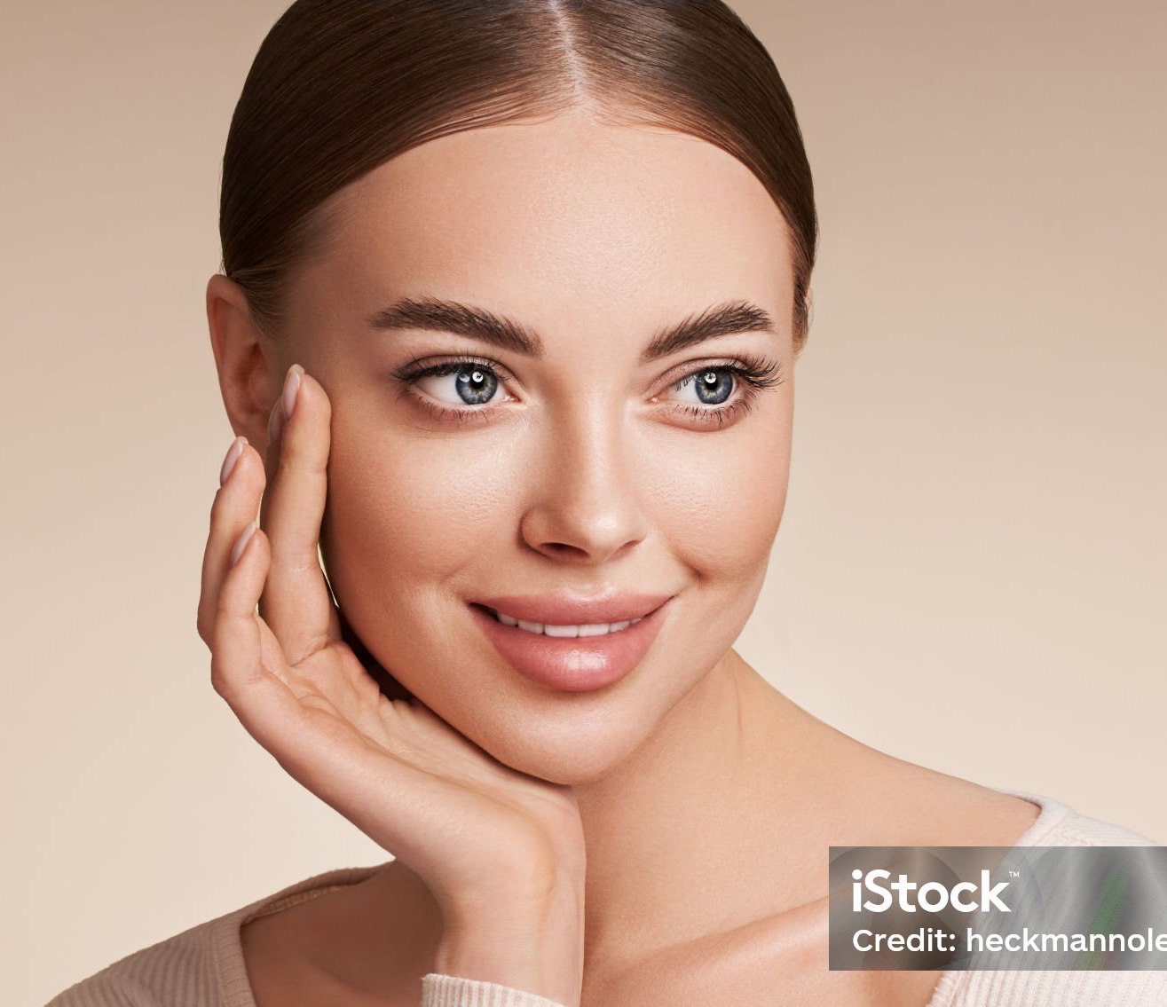 woman rests face in her open palm